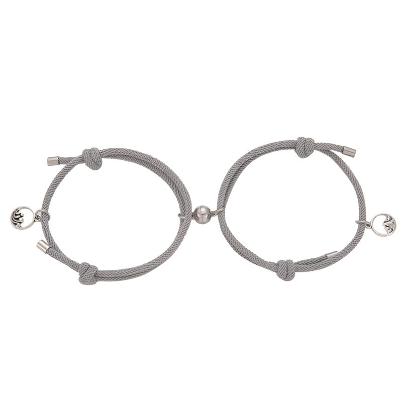 Pair of gray braided New Alloy Eachother Couple Bracelet with silver beads on a white background