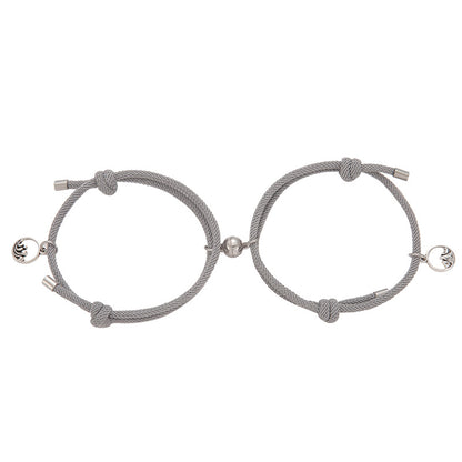 Pair of gray braided New Alloy Eachother Couple Bracelet with silver beads on a white background