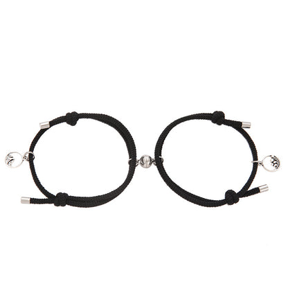 Two black New Alloy Eachother Couple Bracelet with silver beads on a white background
