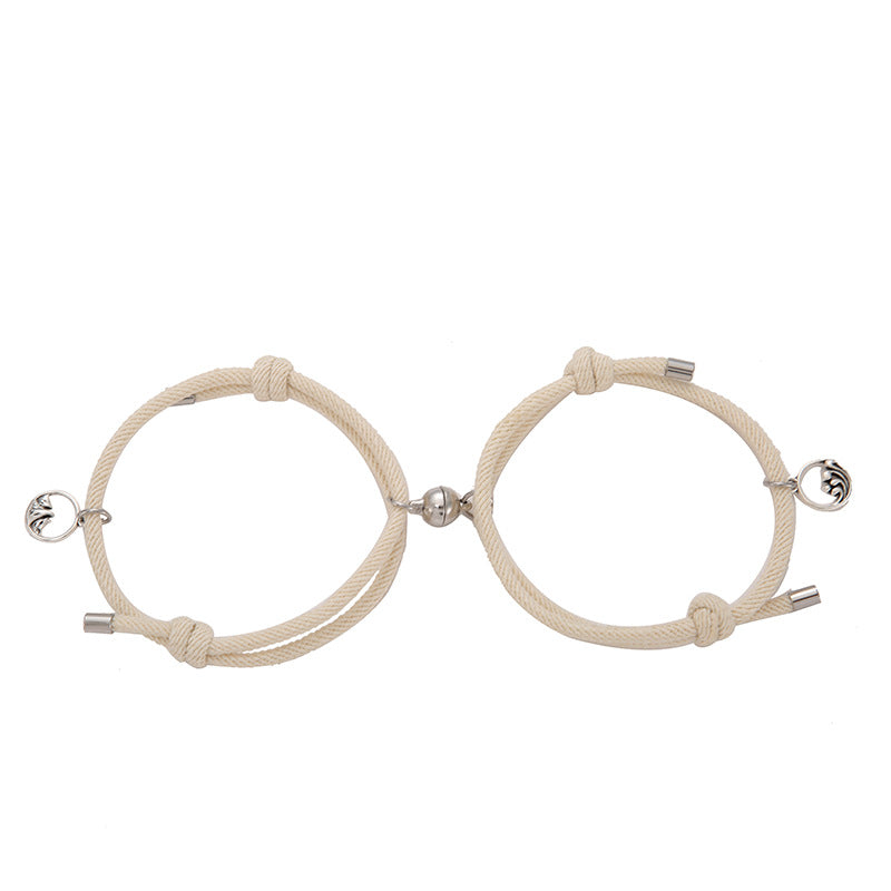 Two beige New Alloy Eachother Couple Bracelets with metal clasps on a white background