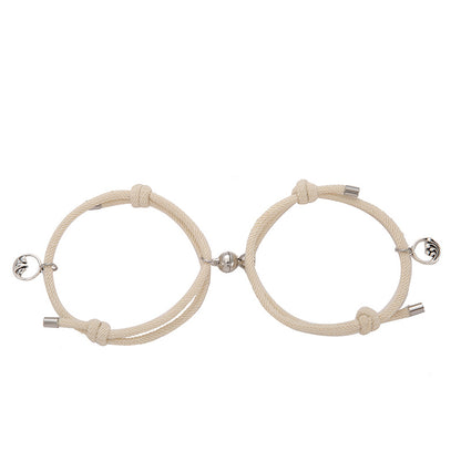 Two beige New Alloy Eachother Couple Bracelets with metal clasps on a white background