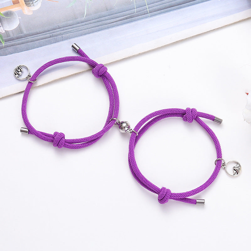 Two purple bracelets with silver ends on a white surface