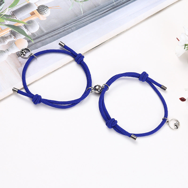Two blue braided bracelets with metal ends on a white surface.